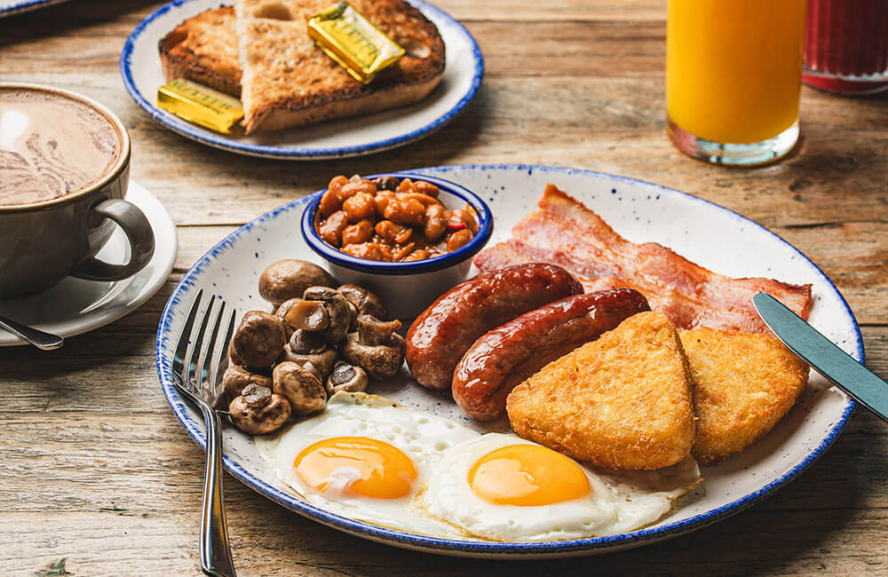 Full English breakfast with toast, coffee and orange juice